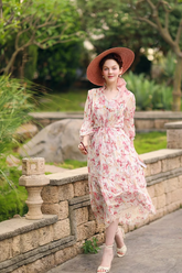 a lady in a pink floral print dress
